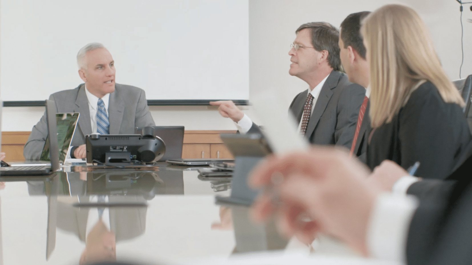 discussing law firm's video marketing at a conference table